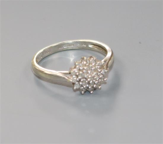 A modern 9ct white gold and diamond cluster ring, size K.